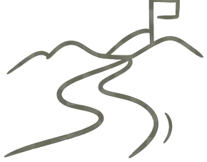 A winding path leading over a hill to a flag